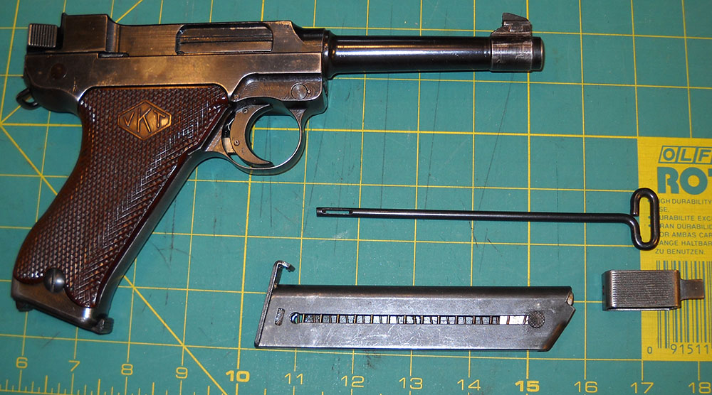 L-35 pistol with cleaning rod, loading tool, and spare magazine